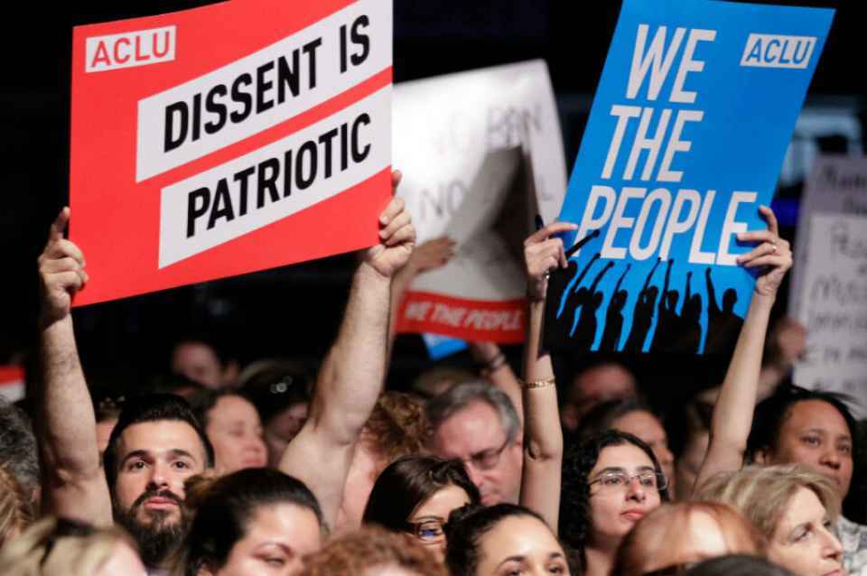 Protesters holding up signs