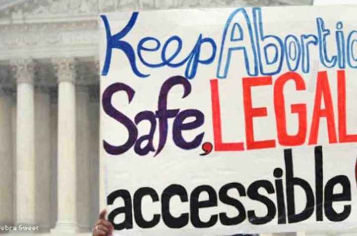Protest sign reading "Keep abortion safe, legal and accessible"